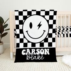 a black and white checkered blanket with a smiley face on it