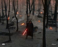 a man standing in the middle of a forest with lights on his hands and holding a light saber