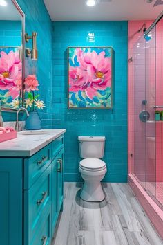 a bathroom with blue walls and pink accents