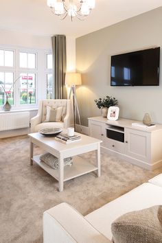 a living room filled with furniture and a flat screen tv