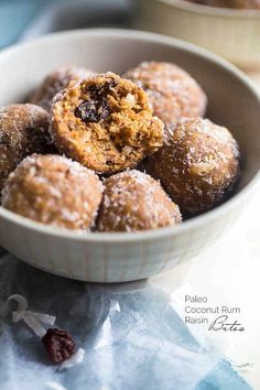 a bowl filled with powdered sugar and raisins on top of a table