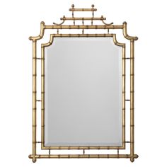 a mirror that is sitting on top of a table next to a white wall and bamboo frame