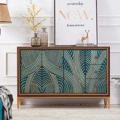 a blue and gold cabinet with an art deco print on it's sideboard