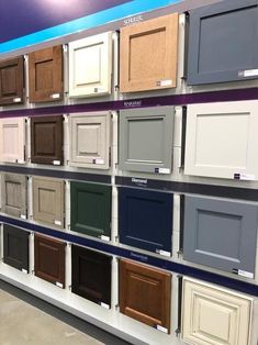 the shelves are full of different colors and styles of cabinet doors, including one for each door