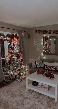 a living room decorated for christmas with a tree in the corner