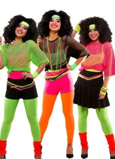 three women wearing neon colored clothing and headbands posing for the camera with their hands on their hips