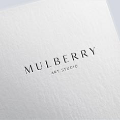 the logo for mulberry art studio is shown on a white paper with black lettering