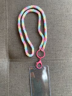 a lanyard with a name tag attached to it and a pink clip on the end