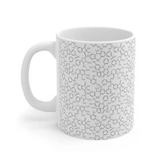 a white coffee mug with an intricate pattern on the inside and sides, sitting against a white background