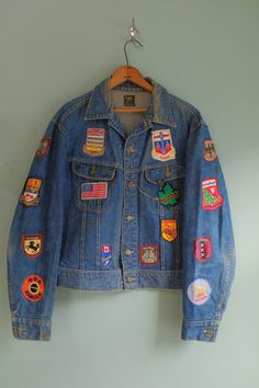 "Amazing 1970's Lee Classic 101 Riders Jacket with customized patches! This unique denim jacket features perfectly faded blue denim, brass metal button closures on the front, and plastic iconic cats eye buttons on the back of the hem. There're customized patches all over the garment from pre-loved own. Perfect to wear with white jeans or your simple casual outfit. Stunning Jacket Rare to Find!  Tag: Lee Union Made  Recommended size for M - XL, depending on how you desired fit.  Measurements  Shoulder 20\" Sleeves  24.5\" Pit to Pit  23\" Length 22.5\" There's one patch on the left side of the sleeve is a bit loose stitch but otherwise, it's a great Vintage Condition *Final Sale" Fun Jean Jacket, Patch Denim Jacket Outfit, Patches On Denim Jacket, Customized Jeans Jacket, Vintage Patches Jacket, Diy Jean Jacket Patches, Patches On Jean Jacket