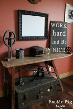 there is a table with an old typewriter on it and a sign that says work hard and be nice