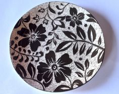 a black and white plate with flowers on it