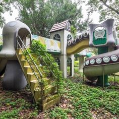 the children's play area is made out of concrete and has green plants growing on it