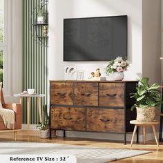 a living room scene with focus on the dresser and flat screen tv in the background