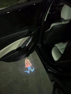 a car door with a sticker on the floor next to it's interior