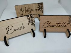 three wooden signs with names on them that say bride, mother of the bride and charlotte