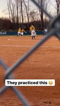 a baseball game is being played behind a fence with the caption, they practice this