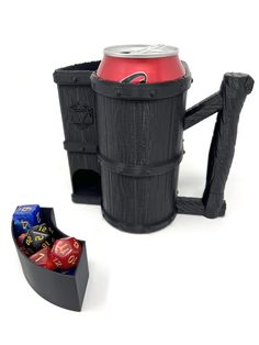 a beer mug with dice in it next to a set of black barrels and two red dice holders