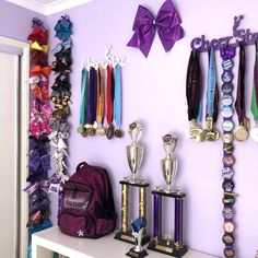 the wall is filled with trophies and ribbons