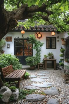 an outdoor patio with stone walkways and potted plants on either side of the house