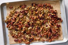 nuts and dried cranberries on a baking sheet