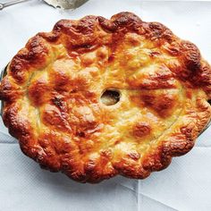 a pie sitting on top of a table next to a fork