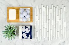 a table topped with soaps and other items on top of a white marble counter