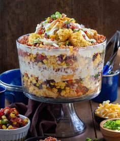 a large glass bowl filled with mexican food