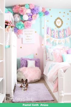 a small dog sitting in the middle of a room with pink and blue decorations on the walls