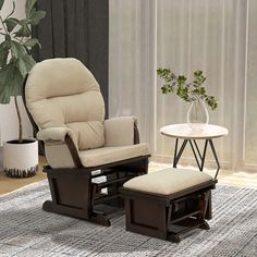 a living room with a chair, ottoman and coffee table in front of a window