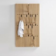 a towel is hanging on the wall next to a rack with wooden slats in it