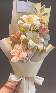 a bouquet of flowers is wrapped in white paper