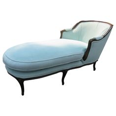 a blue chaise lounge chair sitting on top of a white floor