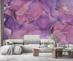 a living room with purple marble wallpaper and white couches in front of it