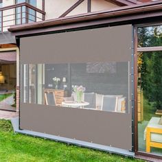 an outdoor living area with sliding glass doors and patio furniture in front of the house