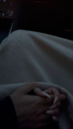 a person holding their hand on the back of a car's passenger seat while it is covered by a blanket