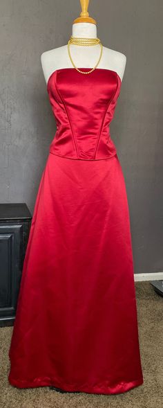 1990s-00's Formal 2 piece Strapless Gown set from Bill Levkoff, size 16 tag (please see measurements for best fit). Crisp Red Thick Satin Polyester fabric, lined in Red soft lightweight Acetate fabric. Fabulous Gown when worn together, or we love a White button down knotted at the waist paired with the skirt, a Graphic T, or Wearing the Bustier top with Jeans, or Tux Pants. Top has Ribbon Corset Lacing at the back- it is Decorative. Supportive Boning, Side zipper with hook and eye at top + Botto Formal Fitted Floor-length Maxi Skirt, Fitted Floor-length Maxi Skirt For Formal Occasions, Red Fitted Skirt For Evening, Evening Holiday Fitted Skirt, Formal Fitted Red Maxi Skirt, Red Satin Skirt For Formal Occasions, Fitted Satin Skirt For Prom, Red Satin Formal Skirt, Fitted Maxi Skirt For Prom Season