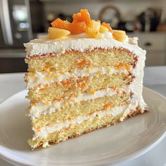 a slice of cake on a plate with white frosting and oranges in the middle