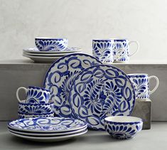 a blue and white dinnerware set on a table