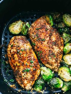 chicken and brussel sprouts in a skillet with some seasoning