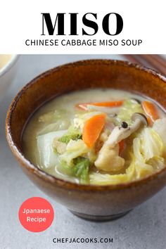 a close up of a bowl of soup with broccoli and carrots in it