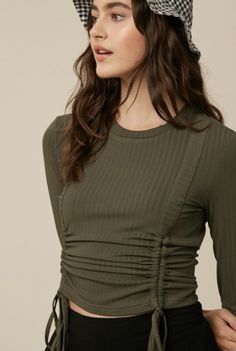 Ribbed round neck ruched knit top Long Sleeve Ruched with adjustable tie strings 100% Polyester Offered in Sizes: Small, Medium, Large Amber Top, Knit Top Long Sleeve, Denim Corset Top, String Top, Ribbed Shirt, Denim Corset, Ruched Top, Plain Tees, Long Sleeve Knit Tops