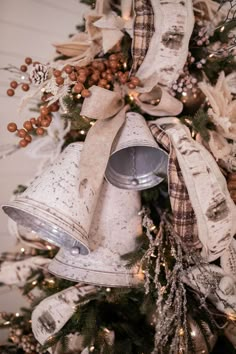 a christmas tree decorated with ribbon and bells