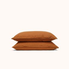 two brown pillows sitting on top of each other