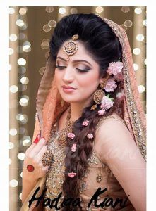 a woman with long hair wearing a bridal outfit and makeup is posing for the camera