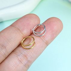 two rings sitting on top of each other in someone's hand