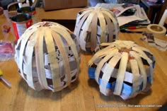 two paper mache balls sitting on top of a wooden table