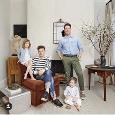 a family poses for a photo in their living room with two children and one adult