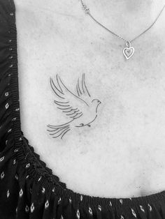 a woman with a dove tattoo on her chest