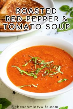 roasted red pepper and tomato soup in a white bowl with toasted bread on the side